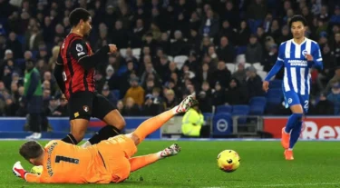 Bournemouth's Amine Adli goes down under the challenge of Bart Verbruggen
